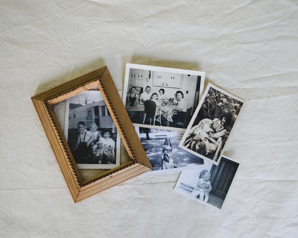 Framed and loose vintage family photos on linen